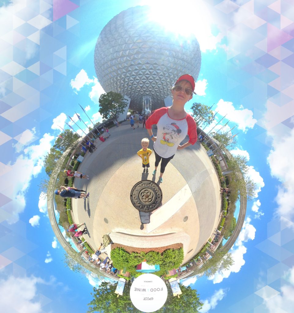 Disney Tiny Planet Magic Shot at Spaceship Earth uses a special camera to capture a 360 degree image which results in making Dani and her3 year old son look very tall and like they are standing on a tiny round planet with Spaceship Earth of Epcot in the background