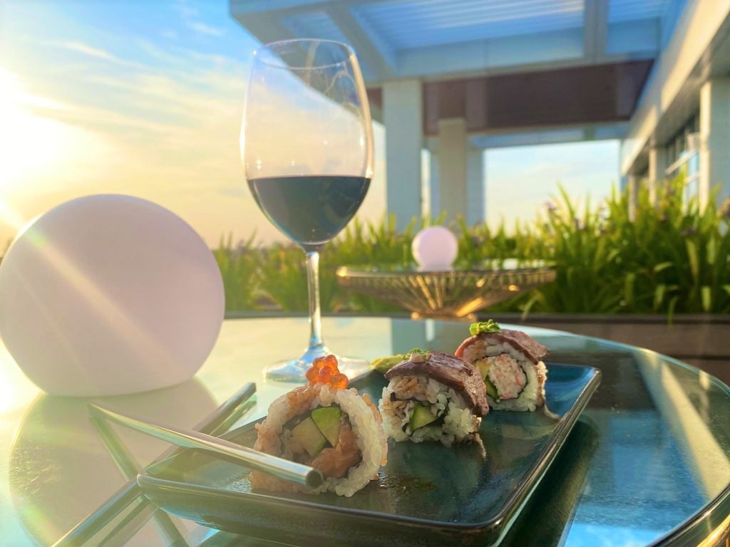 Sushi, red wine, and sunset at illume JW Bonnet Creek rooftop restaurant