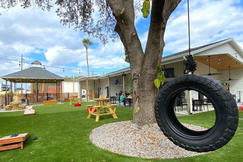 The Yardery at Sanford is child-friendly and fun with a swing set, green synthetic grass and garden games