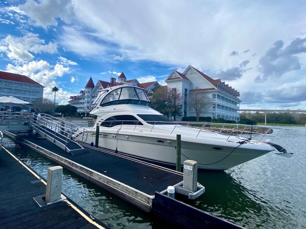 The Grand 1 Yacht at Grand Floridian is a large white yacht. In this photo it is docked at the Grand Floridian resort. 
