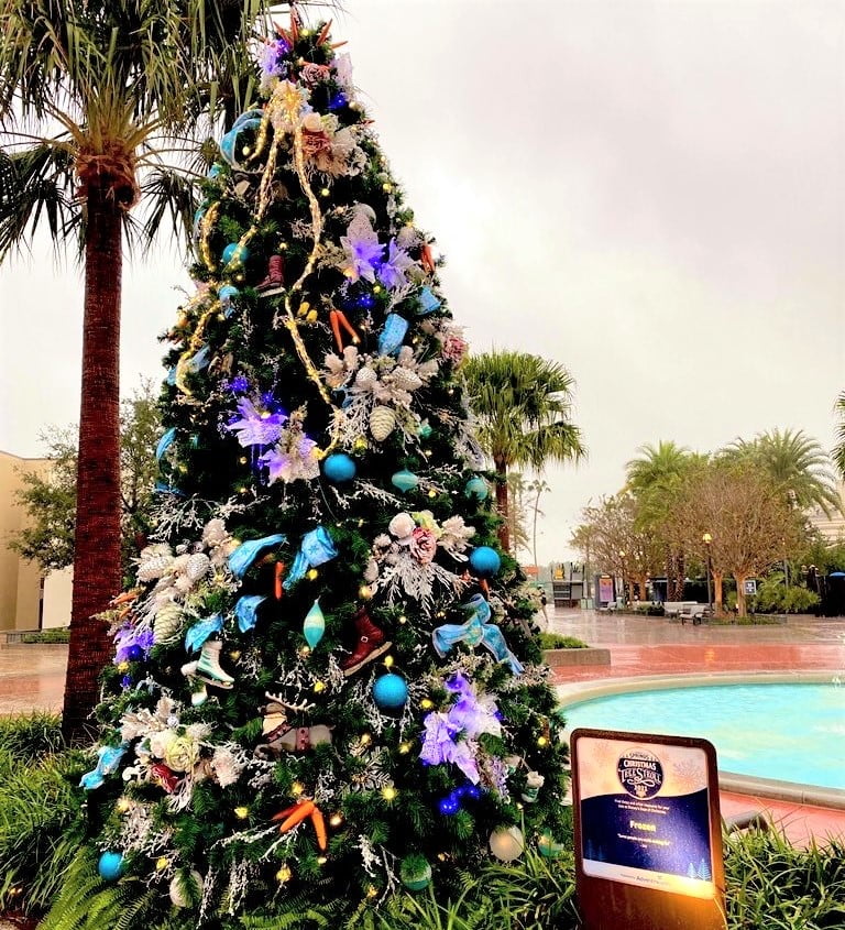A Christmas tree with decorations themed from the movie Frozen has teal blue and purple ornaments as well as reindeer, ice skates, and carrots Christmas Tree Stroll at Disney Springs