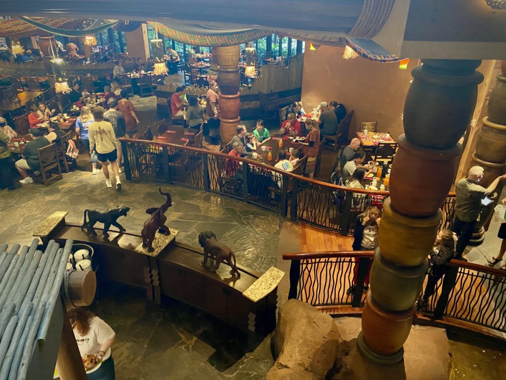 Looking Down at the Buffet of Boma at Disney's Animal Kingdom Lodge - this photo was taken from a landing on a set of stairs that overlooks Boma buffet restaurant, which has rich earth tones and African animals as part of its decor