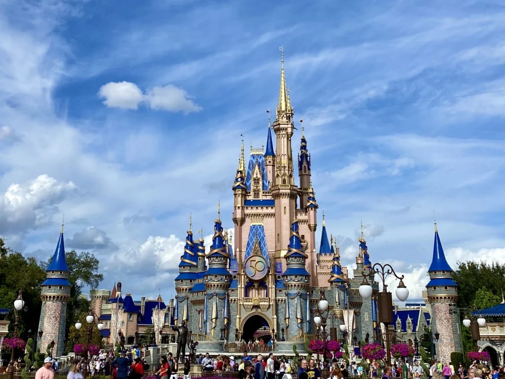 https://www.orlandodatenightguide.com/wp-content/uploads/2022/01/Cinderella-Castle-with-Walt-Disney-World-50th-Anniversary-Emblem-scaled.jpg.webp