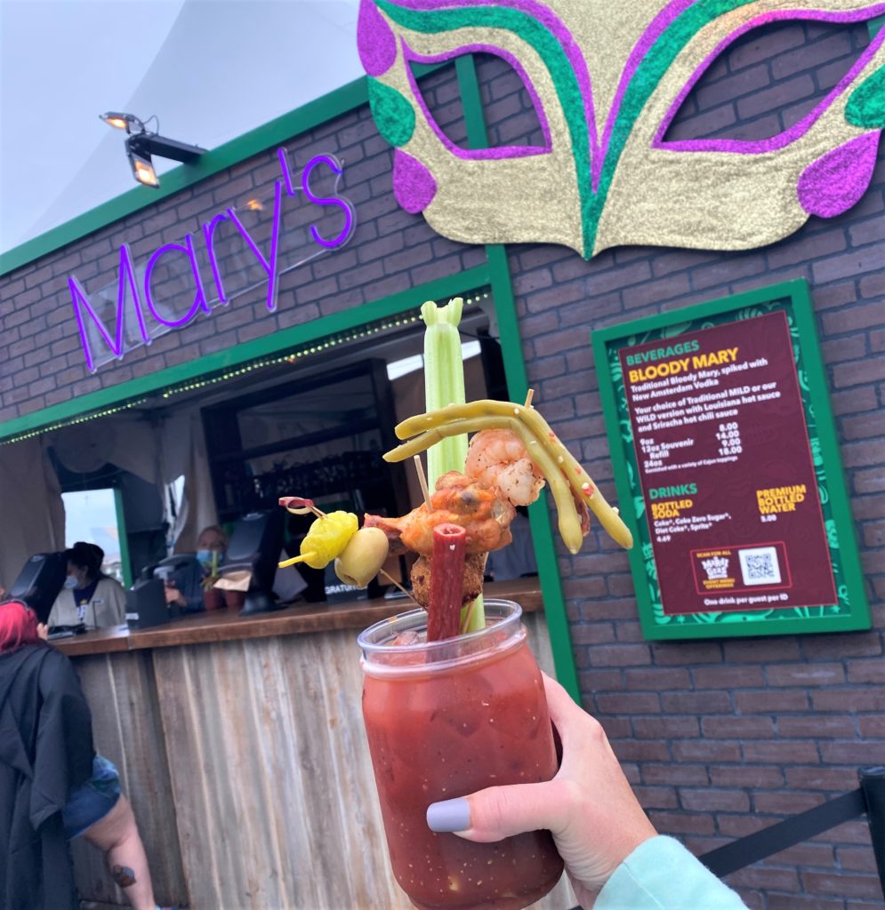 24 oz Bloody Mary with loaded Cajun toppings including one shrimp, one chicken wing, pickled green beans, and more at Universal Mardi Gras 2022