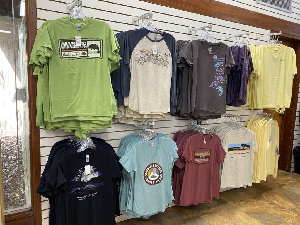 multi-colored t-shirts hang on the walls at Gift shop at Homosassa Springs Wildlife Park