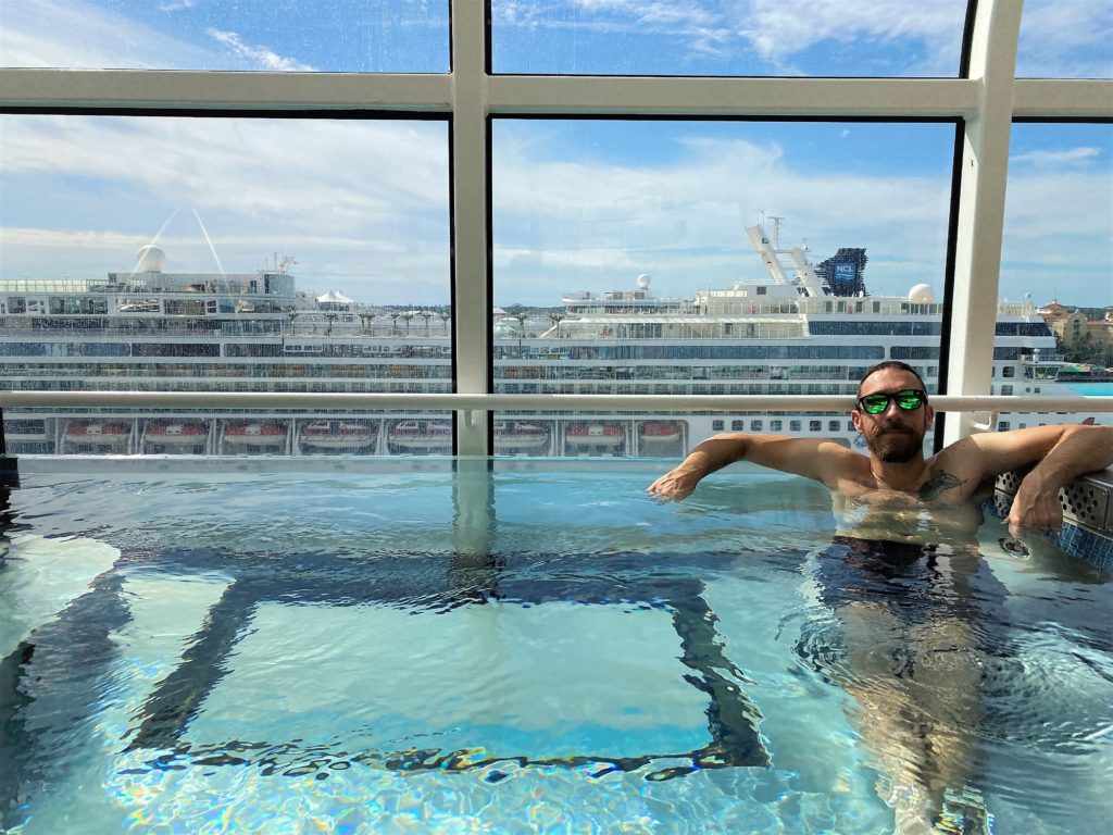 Hot tub overlooking the ocean in the adults only pool deck on Disney Dream includes a clear thick glass panel to see the ocean