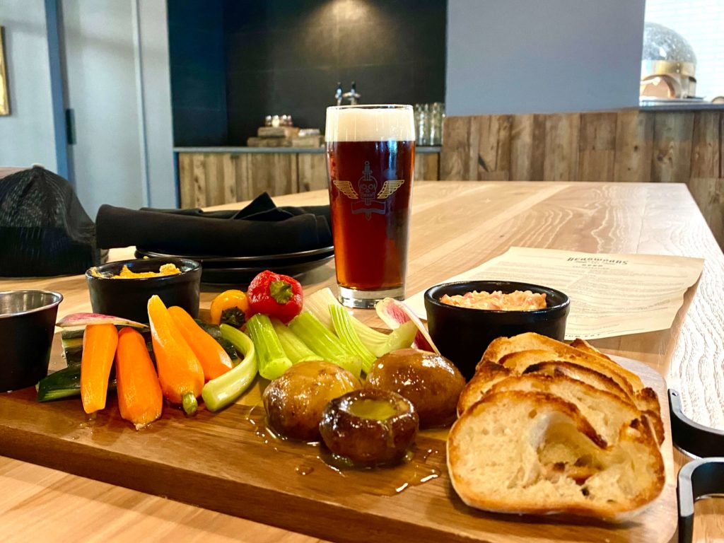 a crudites board and a beer at Deadwords Brewing near downtown Orlando