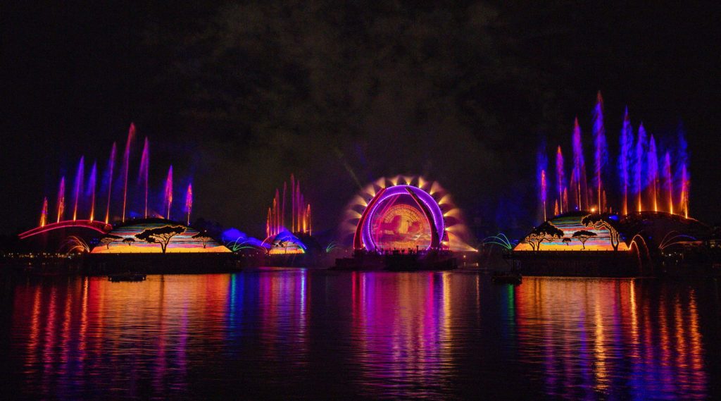 Epcot Harmonious Fireworks with purple, blue, and orange colored fountains