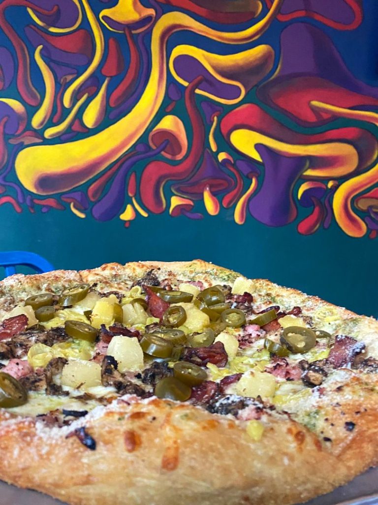 A large pizza with creative toppings at Dog Friendly Winter Park Restaurants - Mellow Mushroom on Aloma 