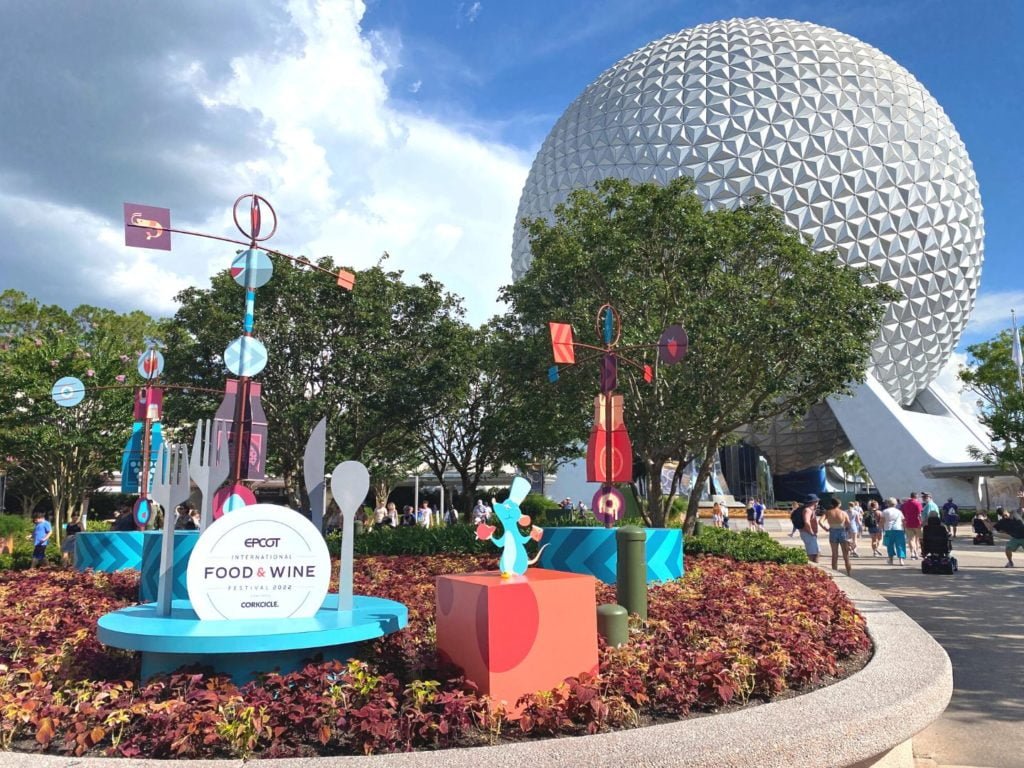 2022 Epcot Food and Wine Festival Entrance with Ratatouille themed signs and decorations and Spaceship Earth in the background