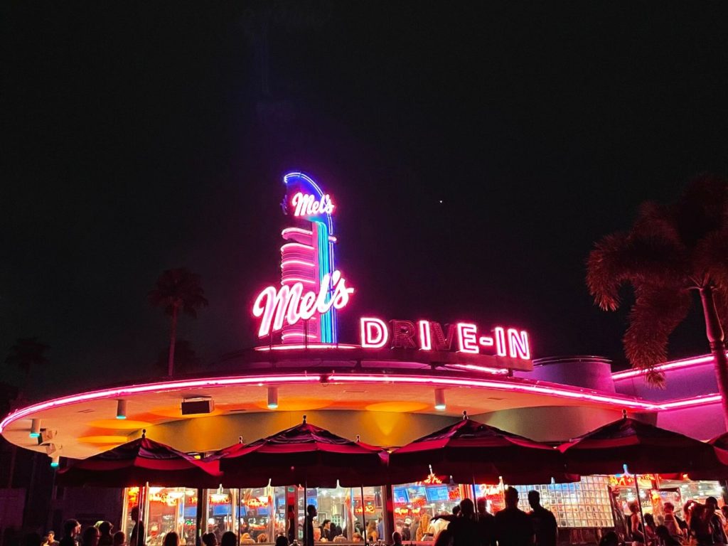 A Halloween Horror Nights Tradition Mel's Die-In in bright neon lights