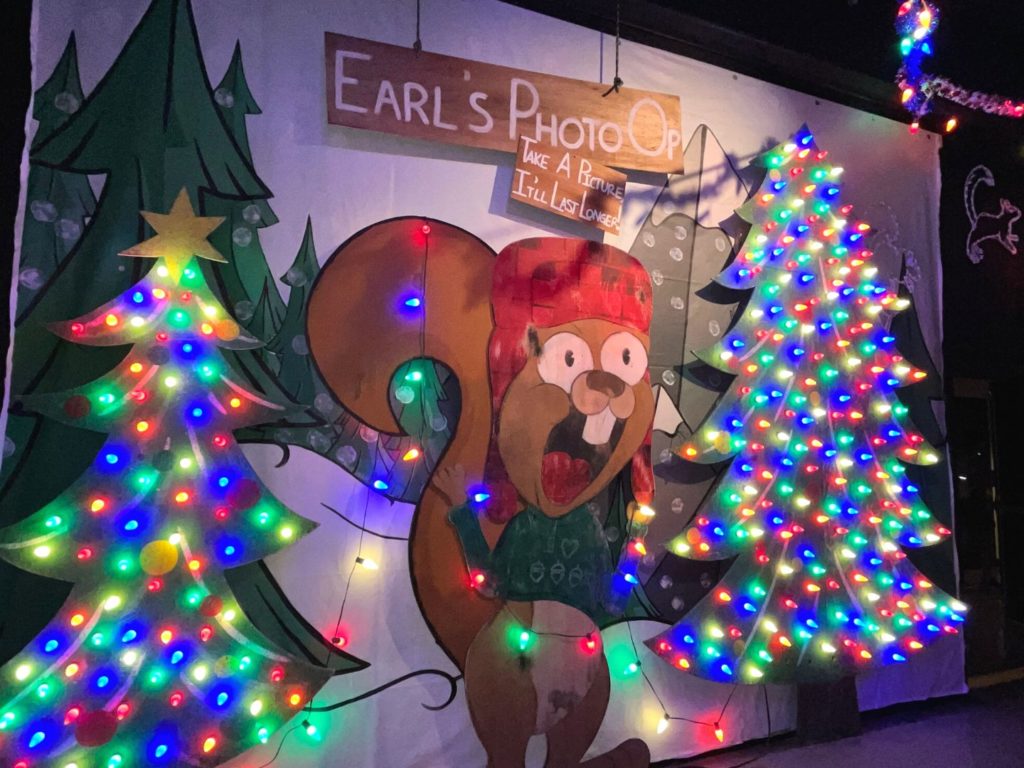 Earl the Squirrel Photo Opportunity with bright colored christmas lights inside Universal's Holiday Tribute Store