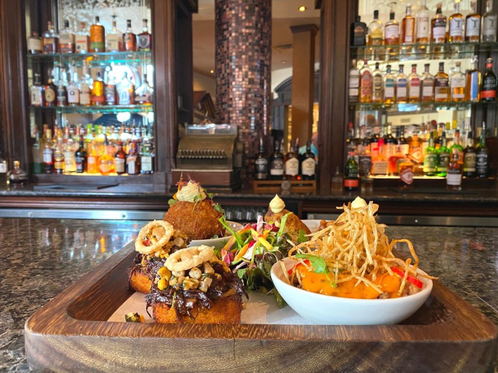 Sharable Appetizer for Two with multiple small plates on a wood platter at Raglan Road Irish Pub and Restaurant - Dani Meyering