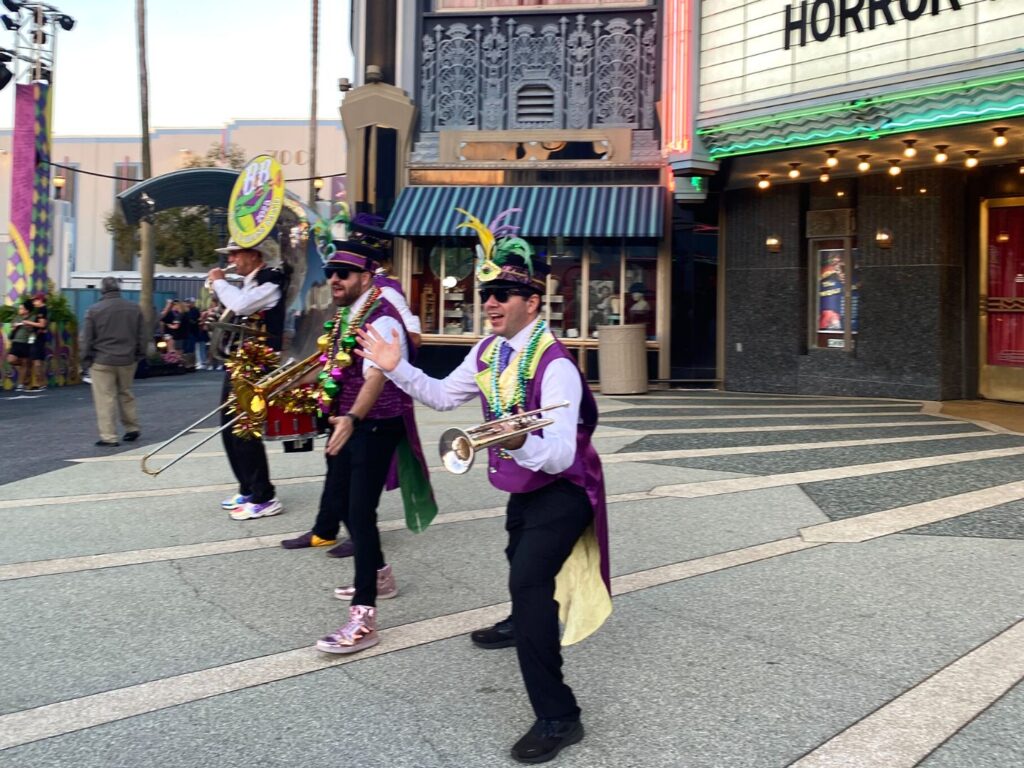 Universal Mardi Gras Band 2023 performing in front of theater