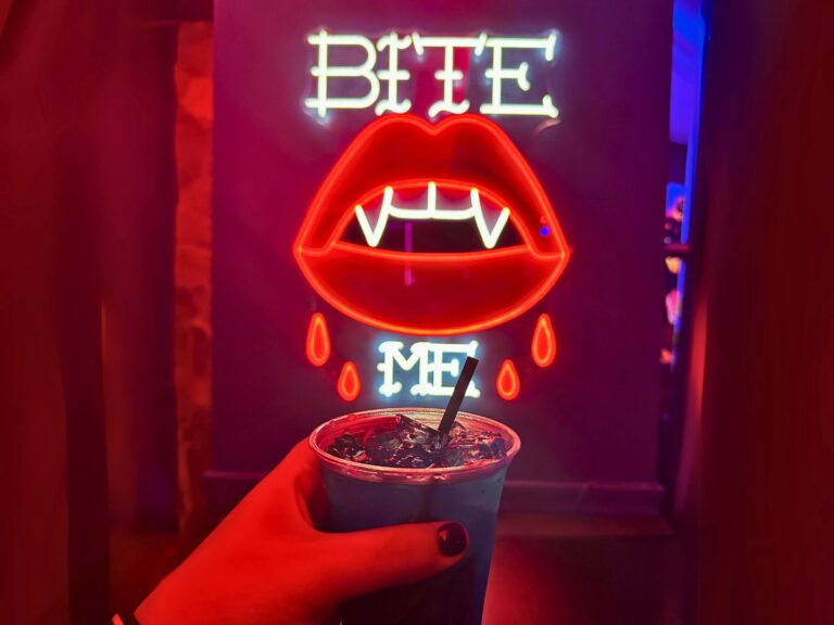 Dead Coconut Club Universal CityWalk Halloween Drink in front of vampire neon sign - image by Jodi Caballero landscape